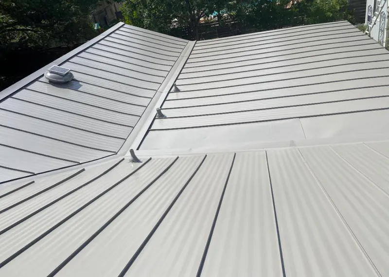 Solar attic fan installed on a metal roof for Roof Ventilation in Griswold